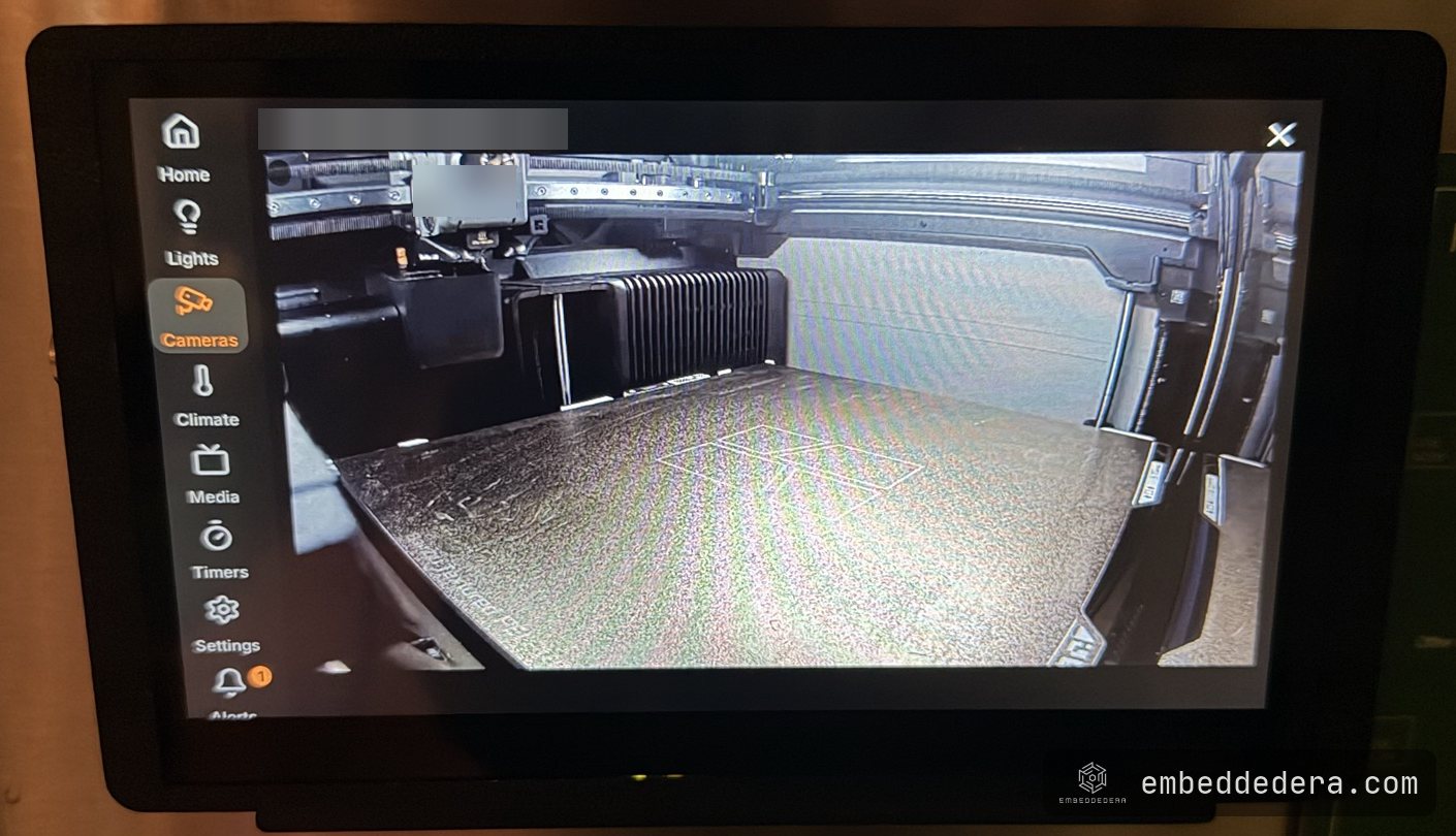 The panel's Cameras page showing a full-screen snapshot from the camera inside a 3D printer, with the sidebar of pages on the left.